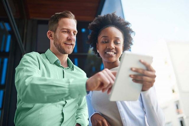 Man and woman looking at tablet together
