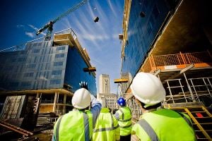 Construction workers walking through building site