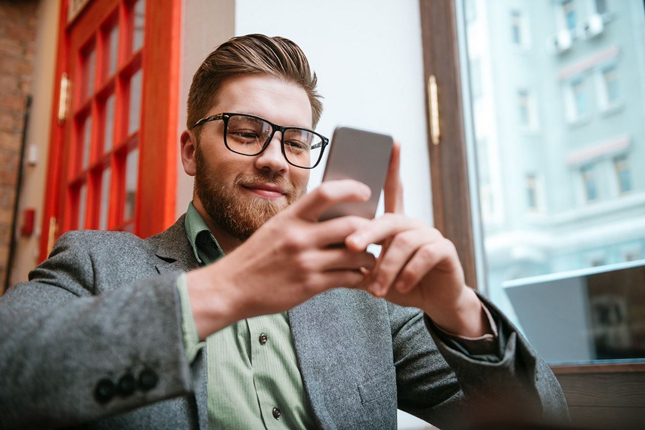 Man looking at his smartphone learning about accounts receivable software