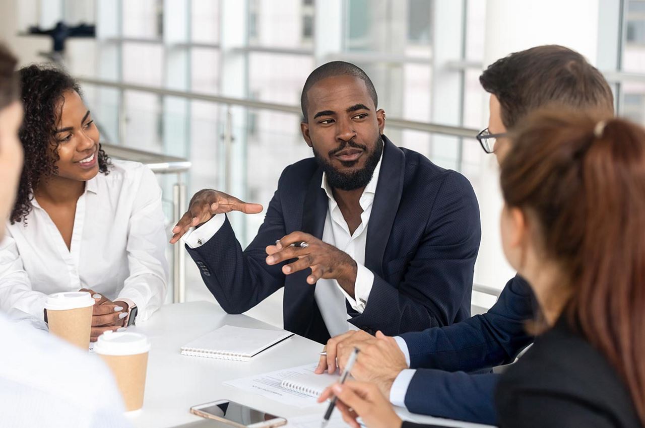 credit manager talking to team in an office