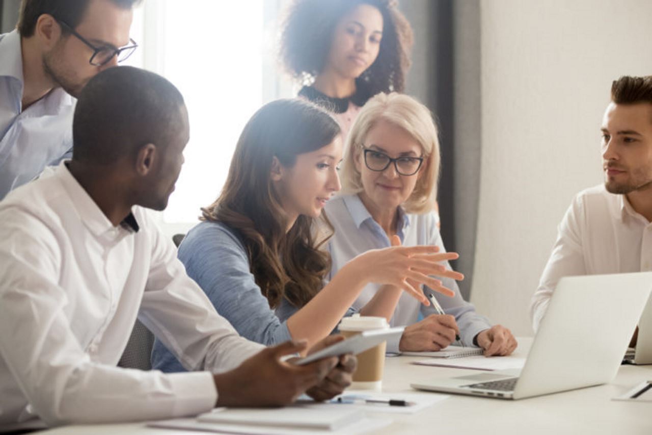 group of employees having a meeting in an office