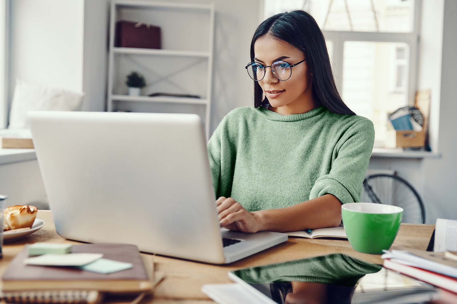 Professional woman in home office using laptop