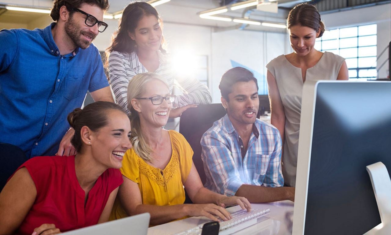 Technology Firm Staff gathering front of computer at Billtrust