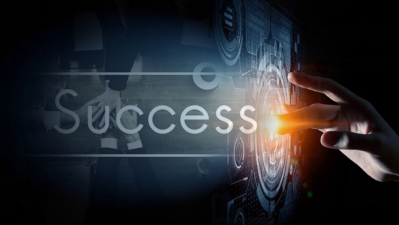 Abstract image of hand touching the word "Success"