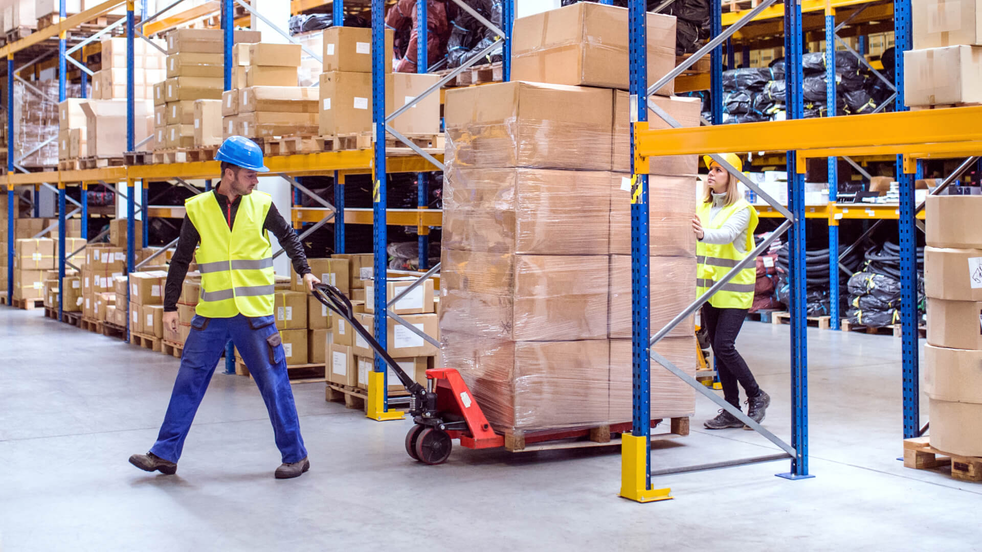 Two warehouse employees working in distribution center