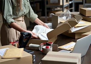 Woman opening retail shipping box