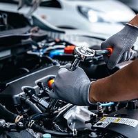 Mechanic working on car engine