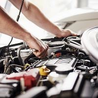 Car mechanic working on engine