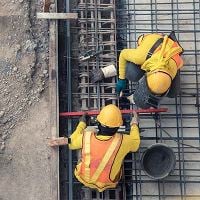 Construction workers pouring concrete