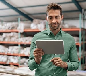 Homme avec une tablette dans un entrepôt