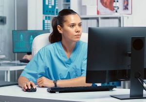 Medical staffer using computer in clinic