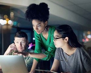 Group of colleagues collaborating at a computer