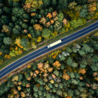 Over-the-road (OTR) truck driving on highway aerial view