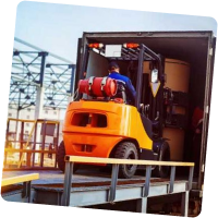 Forklift driving on ramp into back of truck