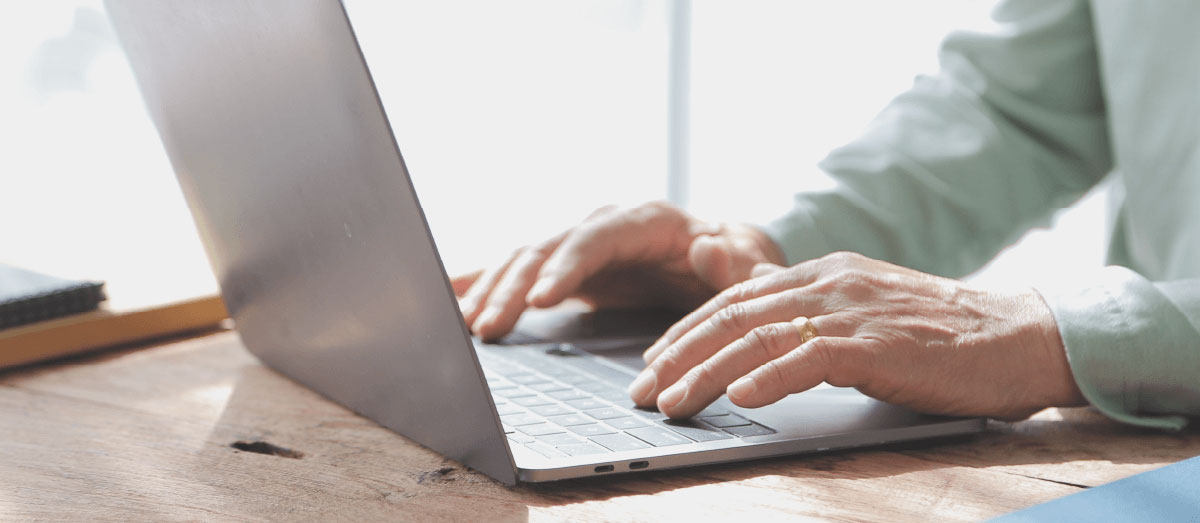 payments analytics man typing laptop keyboard