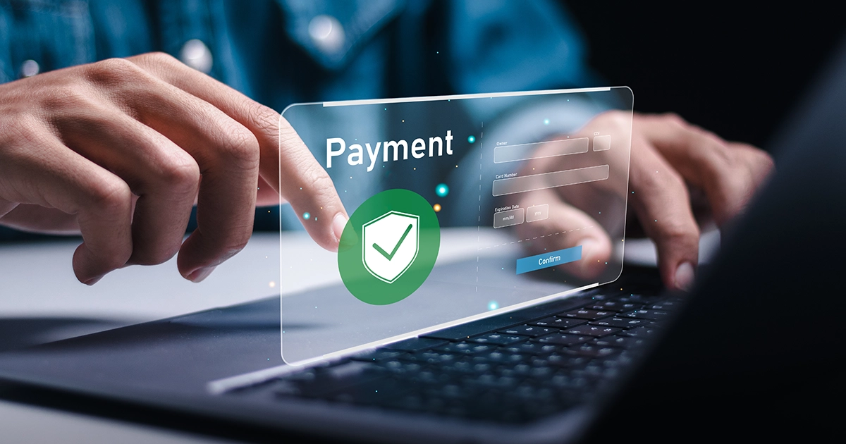 Hands typing on laptop with secure payment popup