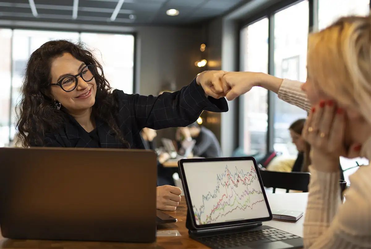 young professional leader fist bumping her teammate