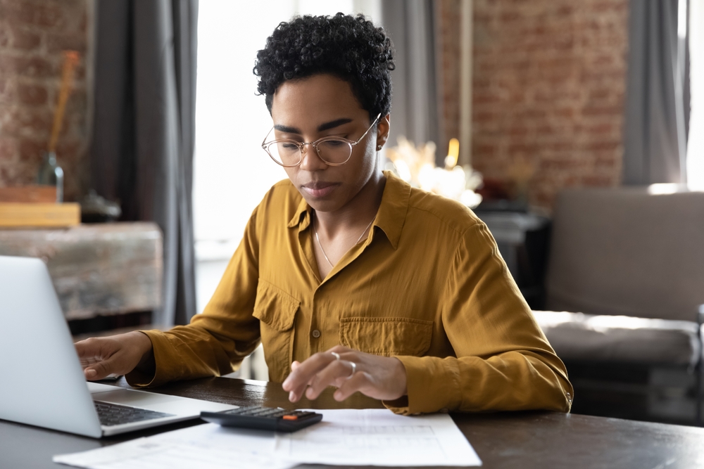 Young professional using a calculator