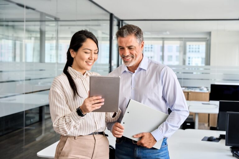Two professionals looking at tablet together