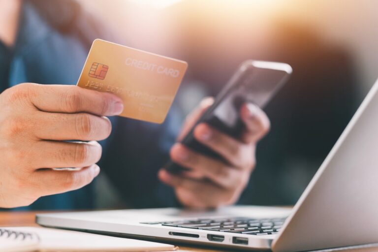 Hands holding credit card and phone