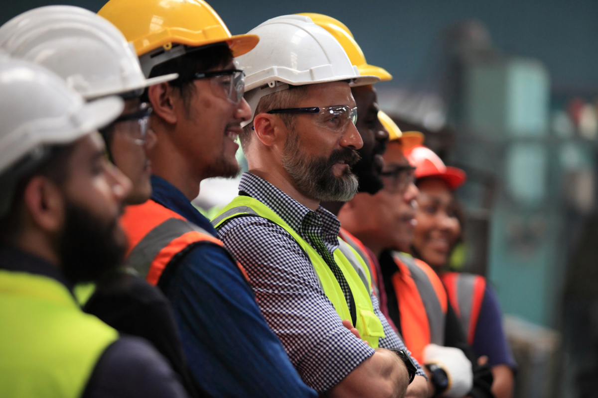 Row of diverse factory workers posing for the camera