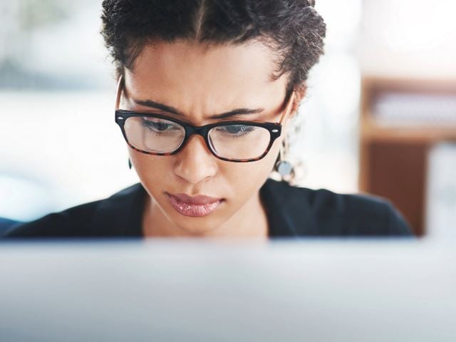 Woman looking concerned at computer screen