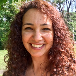 Vrouw die met openluchtachtergrond glimlachen