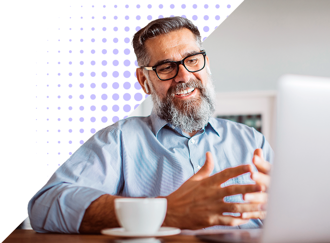 A man with earbuds appears to be in a meeting while on his laptop