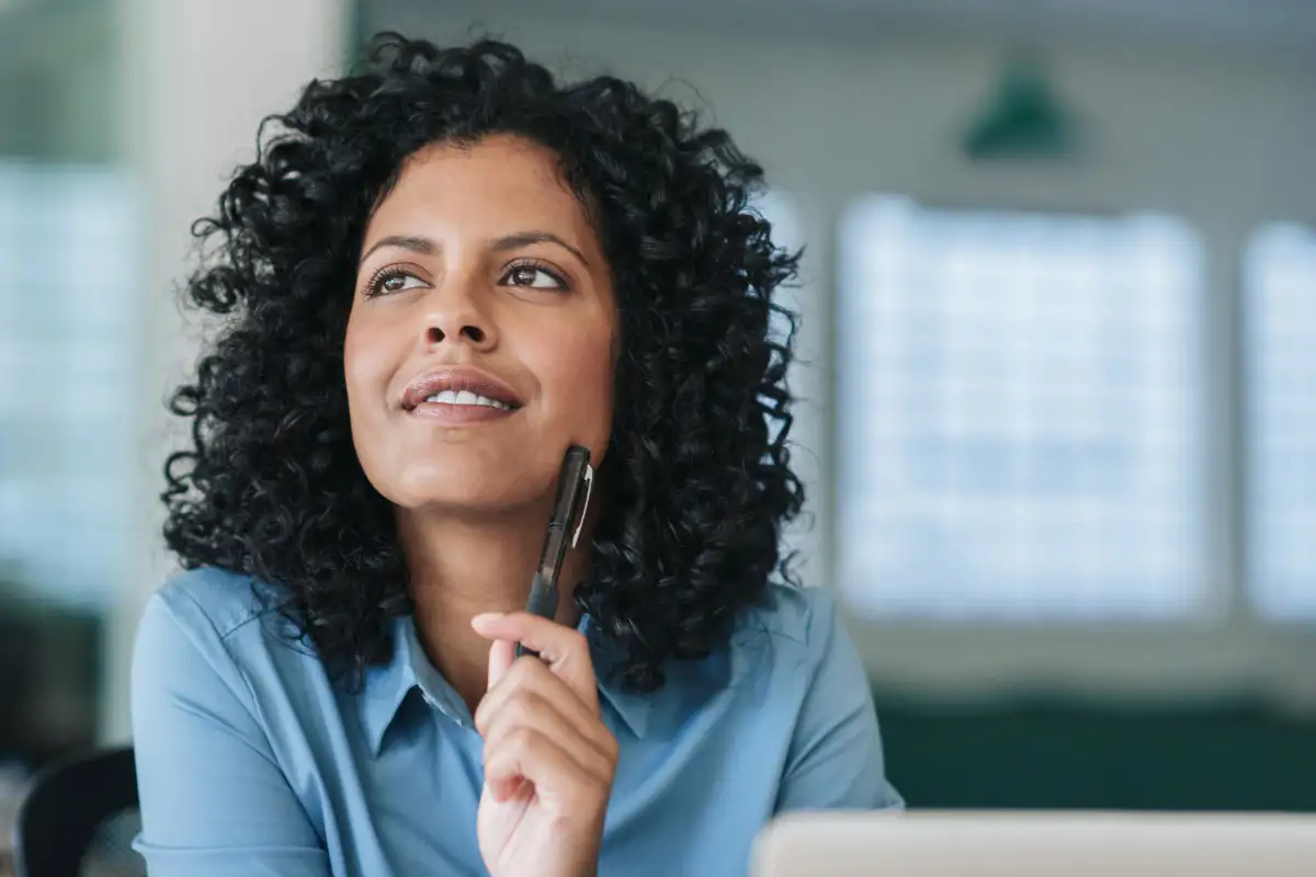 Professional woman thinking with pen