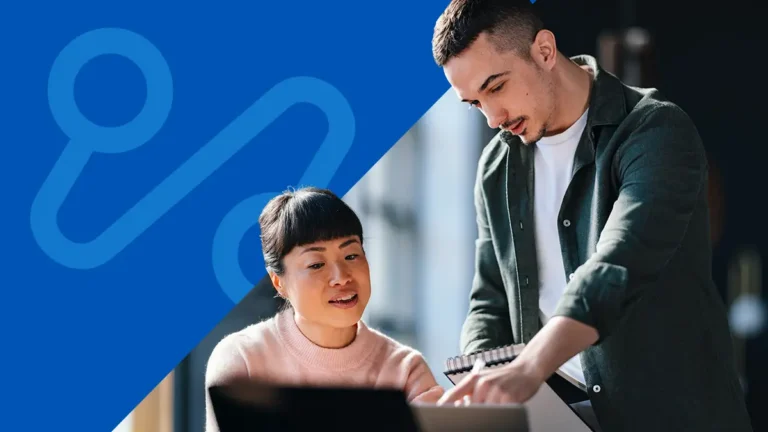 man and woman using computer together