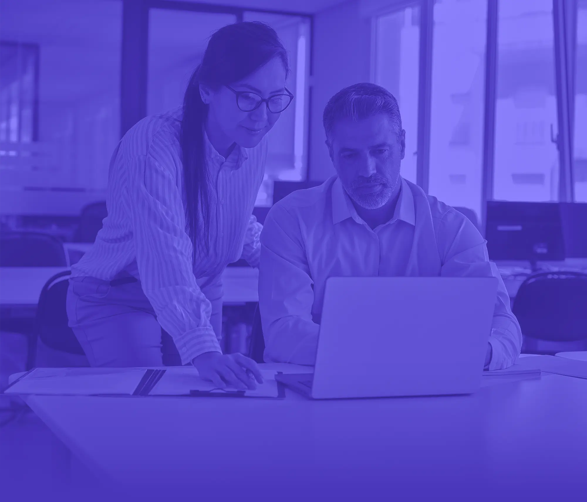man and woman looking at computer together