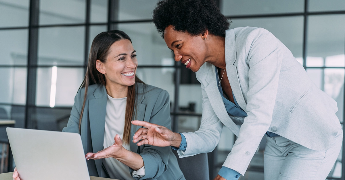 Two women working on laptop