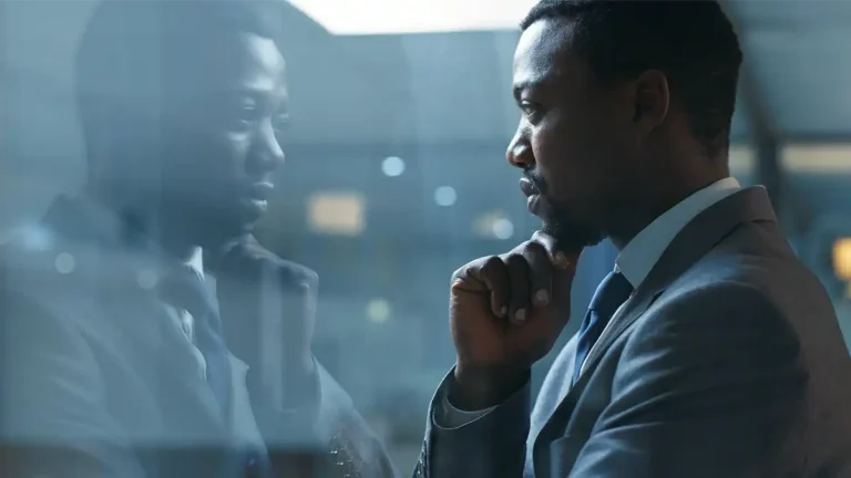 Busniessman looking out window thinking