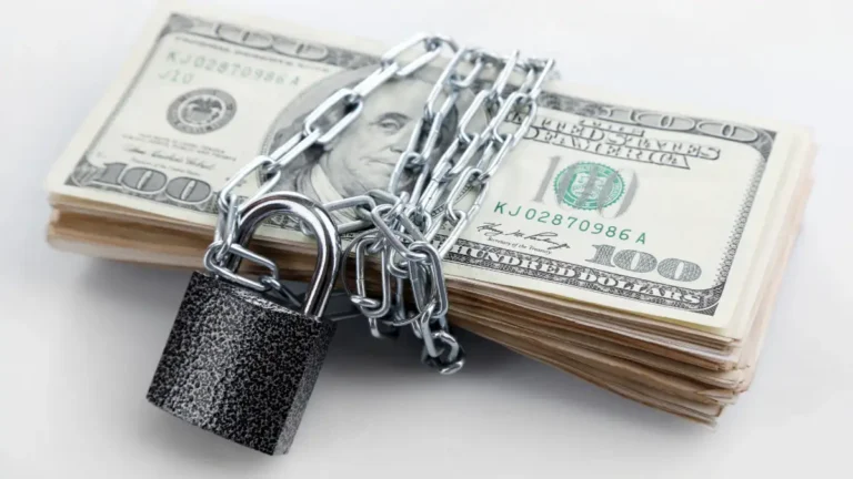 stack of money wrapped with lock and chain