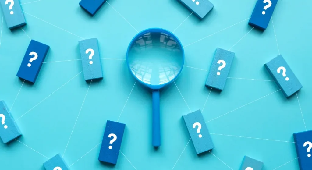 magnified glass with question marks