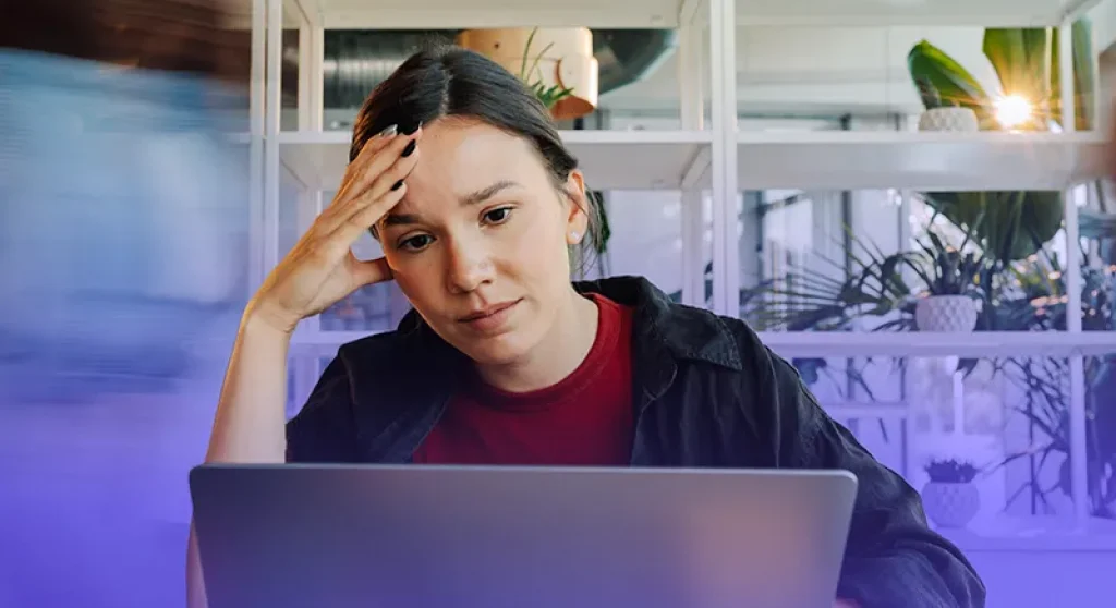 Frustrated woman looking at computer