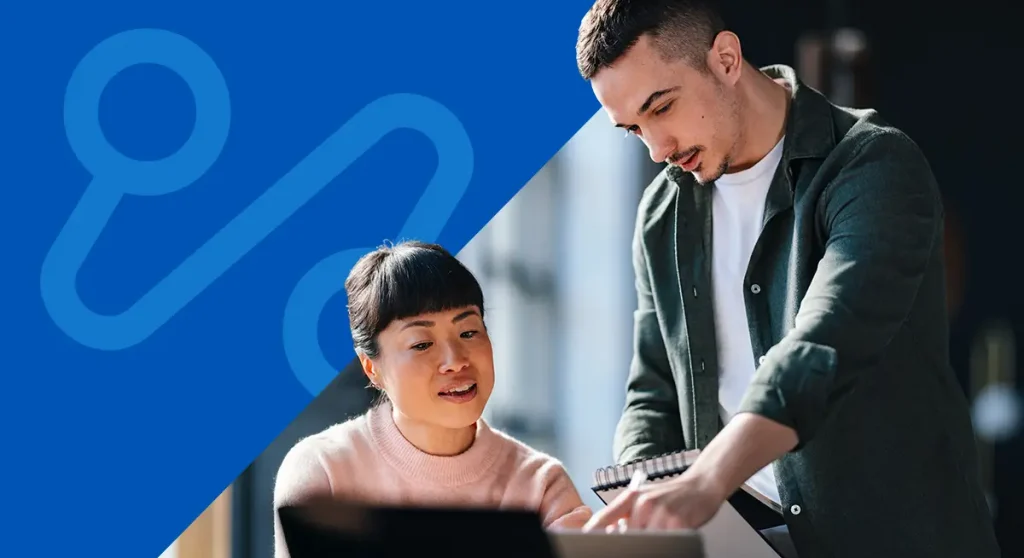 man and woman using computer together