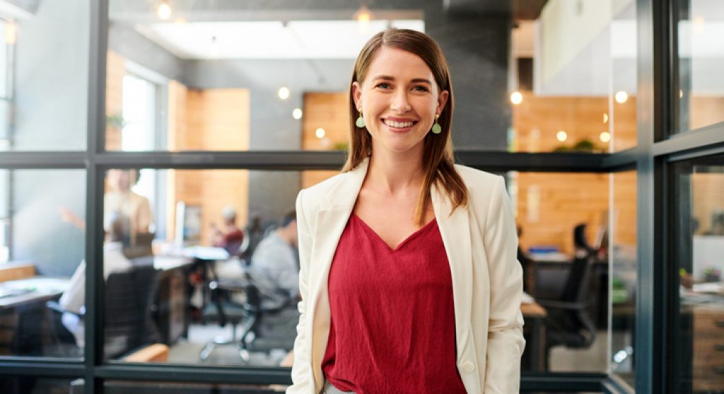Portrait of a confident young businesswoman working in a modern office