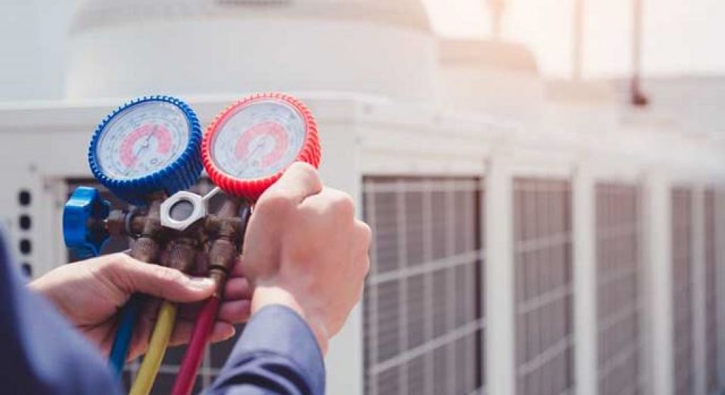 hands holding pressure gauges
