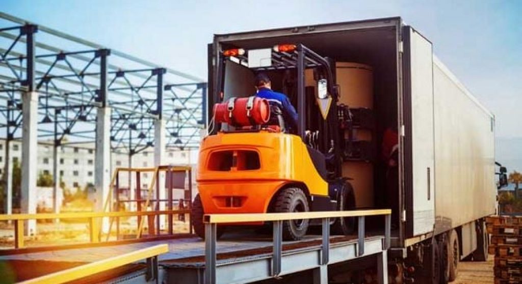 Vehicle loading boxes onto a semi truck