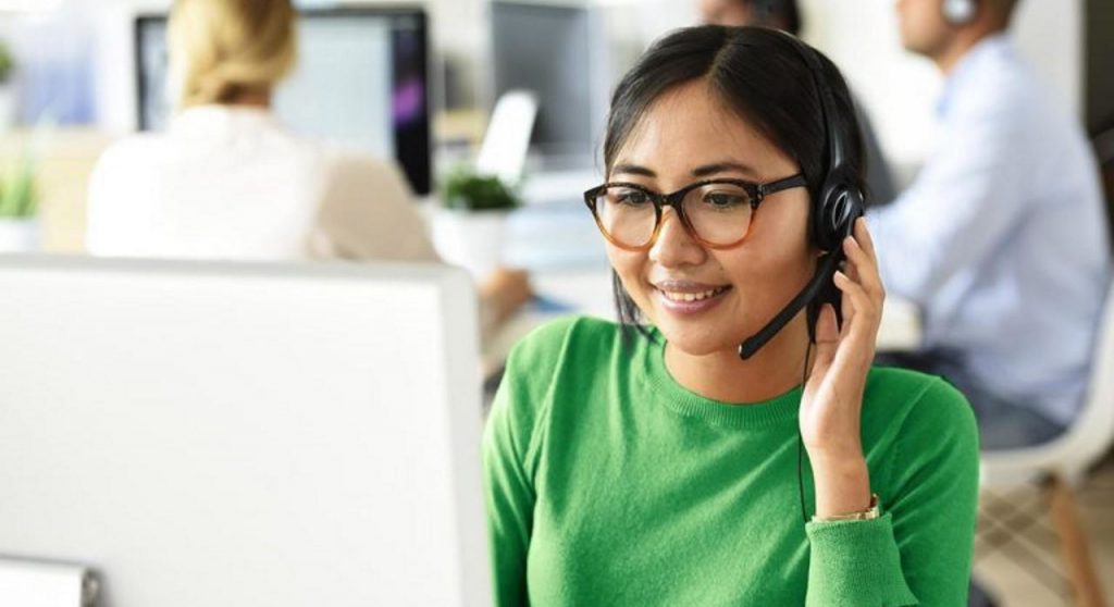customer dissatisfaction-woman sitting in an office in front of a laptop with her left hand on her chin