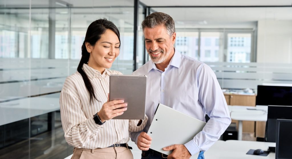 Two professionals looking at tablet together