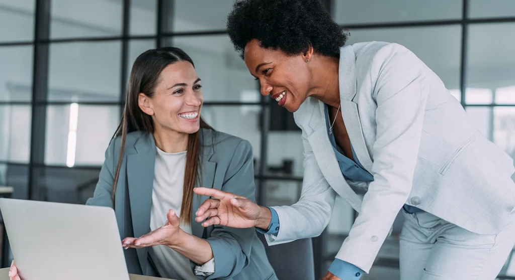Two women working on laptop